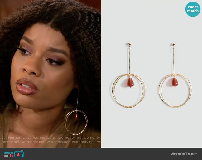 Mango Hanging hoop earrings with ball detail worn by Eva Thomas (Ambyr Michelle) on Beyond the Gates Mango Hanging hoop earrings with ball detail worn by Eva Thomas (Ambyr Michelle) on Beyond the Gates