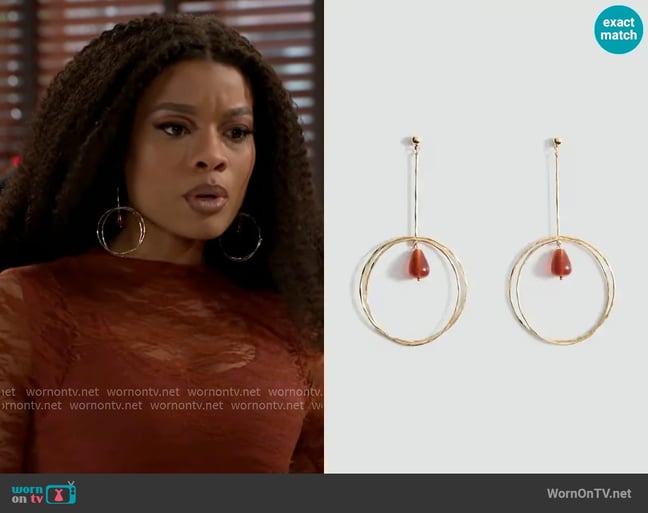 Mango Hanging hoop earrings with ball detail worn by Eva Thomas (Ambyr Michelle) on Beyond the Gates Mango Hanging hoop earrings with ball detail worn by Eva Thomas (Ambyr Michelle) on Beyond the Gates
