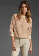 Cream and white colorblock blouse at Revolve