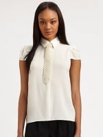 Mindy's white pearl tie top at Saks Fifth Avenue