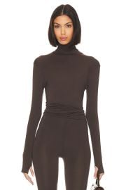 Norma Kamali Slim Fit Long Sleeve Turtle Top in Chocolate at Revolve