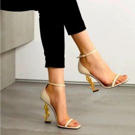 Saint Laurent Opyum Sandals in smooth leather with a gold tone heel at Net a Porter