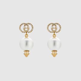 Shiny Gold Finish Interlocking G Earrings With Pearl US at Gucci