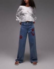Topshop mid rise loose fit jeans with red floral embroidery in mid blue at ASOS