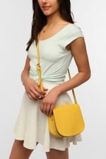 Yellow saddle flap bag at Urban Outfitters at Urban Outfitters