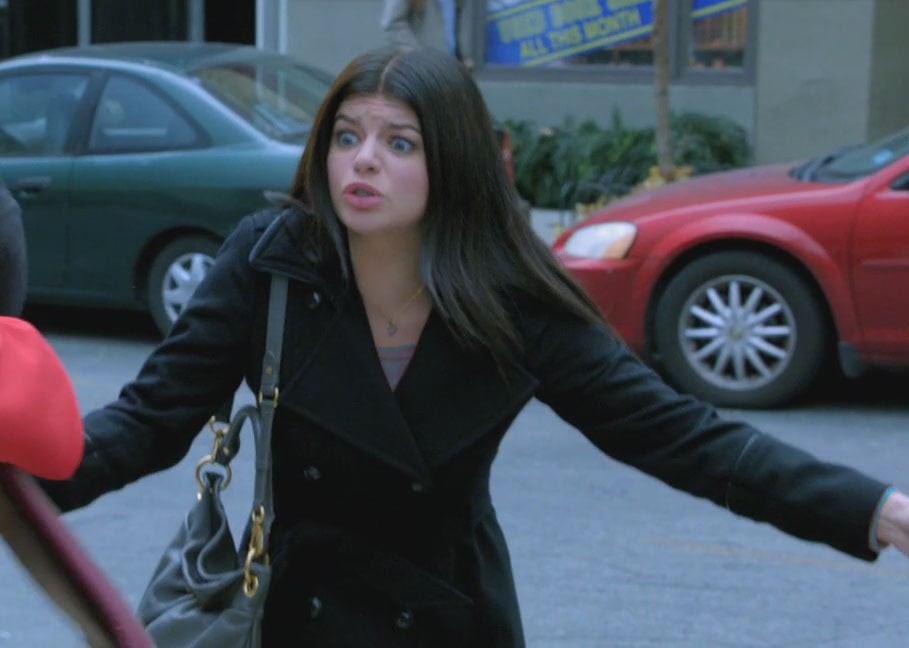Penny's black coat and blue bag on Happy Endings