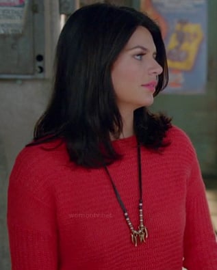 Penny's red knit sweater and long leather/gold necklace on Happy Endings