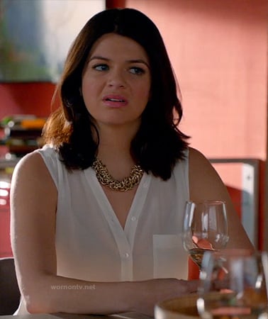 Penny's white sleeveless button front top on Happy Endings
