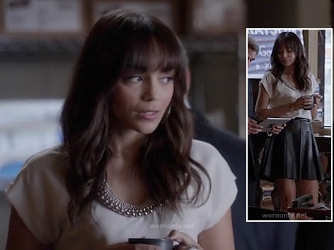 Ashley's white top with beaded neckline and black leather skirt on Revenge
