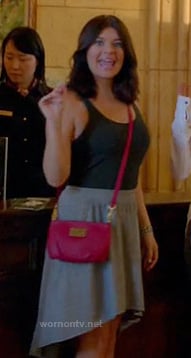 Penny's grey dipped hem skirt and red crossbody bag on Happy Endings