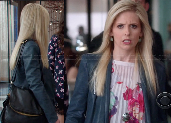 Sydney's blue leather jacket, floral pleated blouse and black foldover bag on The Crazy Ones