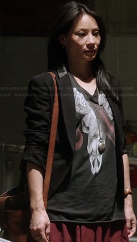 Joan's black ram skull and snake graphic tee on Elementary