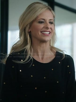 Sydney's black and gold polka dot studded dress and gold dagger earrings on The Crazy Ones