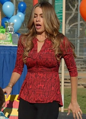 Gloria's red snakeskin top with chain neckline on Modern Family