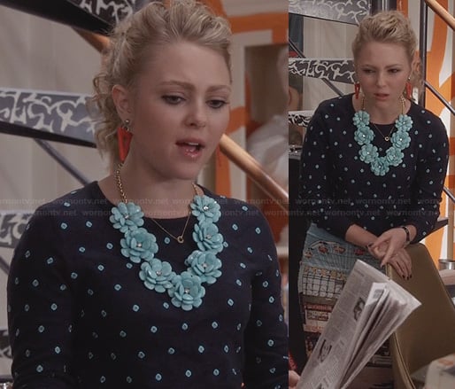Carrie's navy and turquoise polka dot sweater, flower necklace and graphic printed skirt on The Carrie Diaries