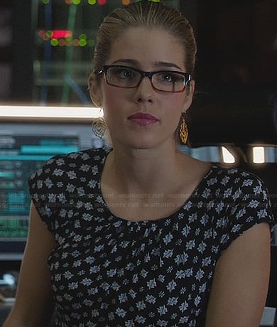 Felicity's printed peplum dress and peacock feather earrings on Arrow