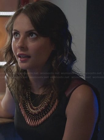 Thea's black dress with burgundy leather shoulders on Arrow