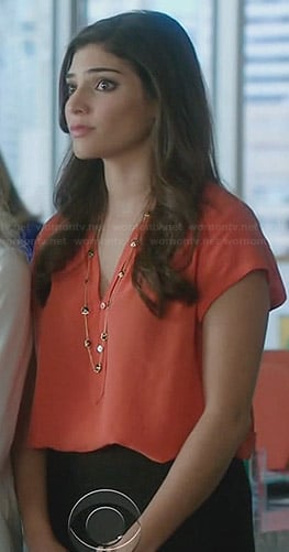 Lauren's orange blouse and black strand necklace on The Crazy Ones