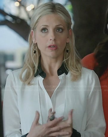 Sydney's white blouse with black leather collar and cuffs on The Crazy Ones