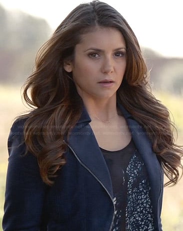 Elena's printed top, blue jacket and 