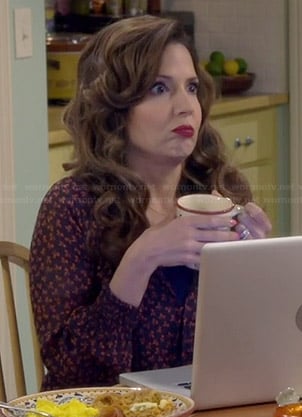 Daniela's navy and red printed blouse on Cristela