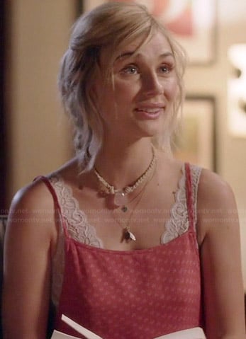 Scarlett's red printed apron style dress and white lace bra on Nashville