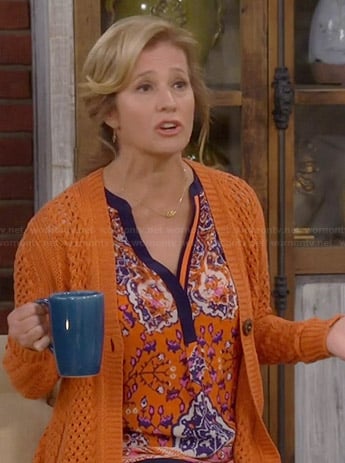 Vanessa's orange printed blouse and crochet cardigan on Last Man Standing