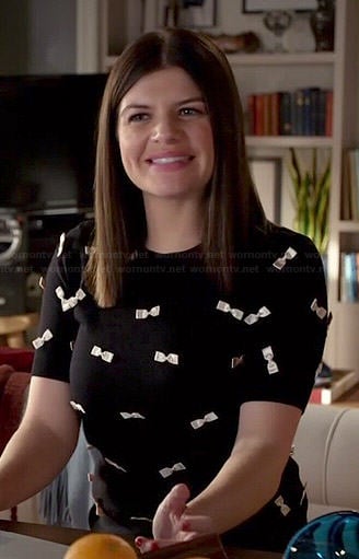 Annie's black top covered in white bows on Marry Me
