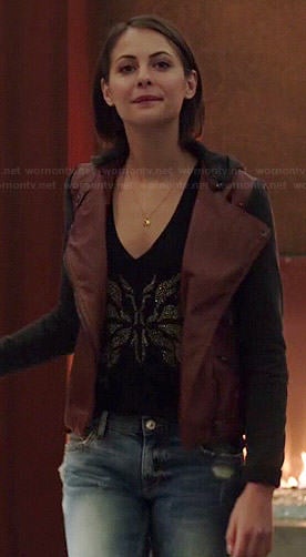 Thea's burgundy leather jacket with black sleeves and hood on Arrow