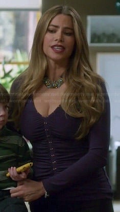 Gloria's purple studded v-neck top on Modern Family