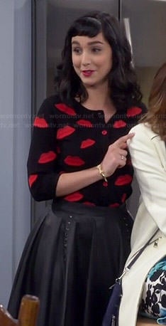 Mandy's lips cardigan and leather skirt on Last Man Standing