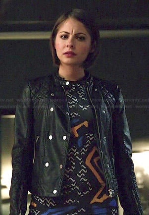Thea's graffiti printed dress and leather jacket on Arrow