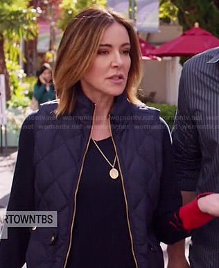 Ellie's navy sweater with red cuffs and quilted vest on Cougar Town