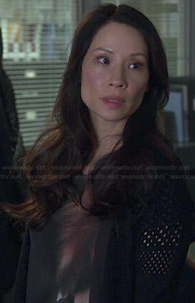 Joan's black and orange printed top on Elementary