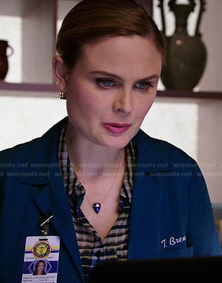 Brennan's plaid blouse and blue triangle necklace on Bones