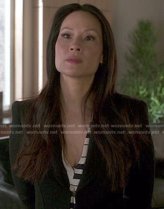 Joan's striped dress and long black coat on Elementary