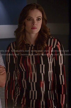 Caitlin's black, white and red printed long sleeve top on The Flash