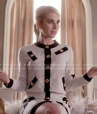 Chanel's white jacket and skirt set with black trim and gold buttons on Scream Queens