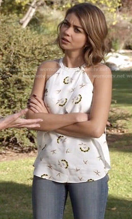 Haley's white printed top and ankle boots on Modern Family