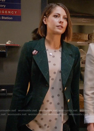Thea's medallion dotted top and green checked blazer with leather details on Arrow
