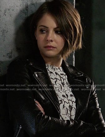 Thea's black and white printed top and leather jacket on Arrow