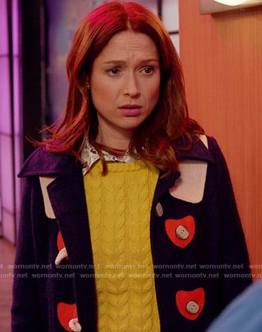 Kimmy's navy toggle coat with red hearts on Unbreakable Kimmy Schmidt