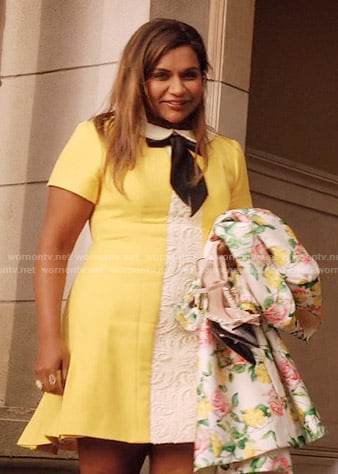 Mindy's yellow dress with white lace panel and tie neck and floral coat on The Mindy Project