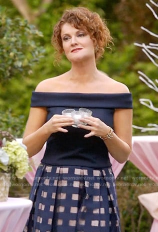 Evelyn's navy off-shoulder top and windowpane skirt on Devious Maids