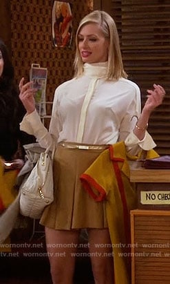 Caroline's high neck blouse and yellow pleated skirt on 2 Broke Girls