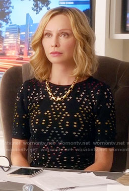 Cat's black perforated top and skirt on Supergirl