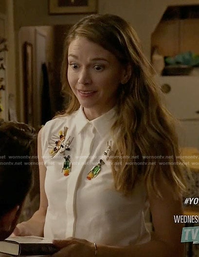 Liza's white sleeveless shirt with bead embellishments on Younger