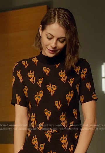 Thea's black and orange flower print top on Arrow