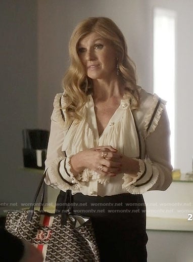Rayna's crema ruffled blouse with pearl buttons on Nashville