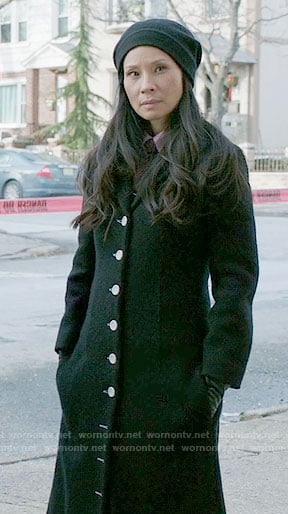 Joan's long black coat with white buttons on Elementary